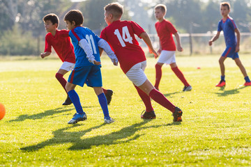 Obraz premium Boys kicking ball