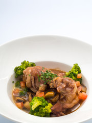Rooster cooked in red wine.