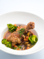 Rooster cooked in red wine.