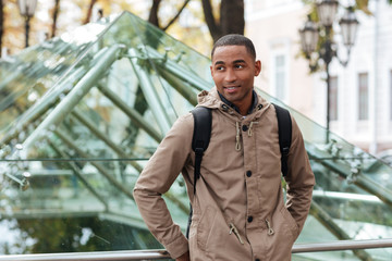 Happy african young man walking in the street