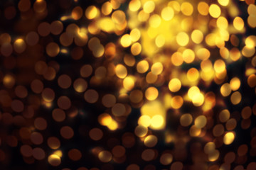 Abstract Christmas glitter vintage lights background. Dark Gold