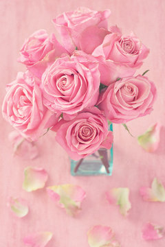 Close-up floral composition with a pink roses .Many beautiful fresh pink roses on a table.Vintage style .