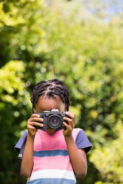 A child is taking picture with camera