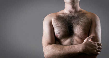 Man with hairy chest isolated on gray background for text.