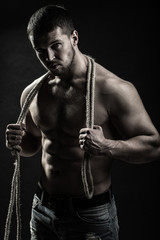 Obraz na płótnie Canvas Muscular man with rope