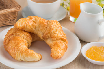 Croissants with coffee cup and fruit jam
