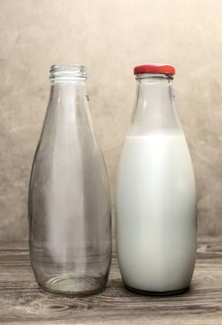 two glass milk bottle, one empty