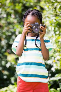 Portrait of boy taking pictures