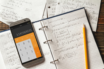 Mathematical equations written in a notebook. Calculator app.