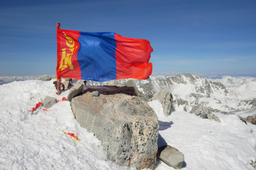 Waving flag of Mongolia on top of Mount Munku-Sardyk (also known as Monkh Saridag). Sayan Mountains, International border between Mongolia and Russia. - 128728166