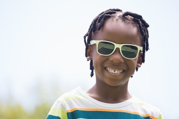 A kid with sunglasses smiling