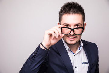 Portrait  of Bearded man look over glasses