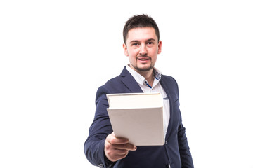 Portrait of a smiling bearded guy in suit giving book to camera over white background