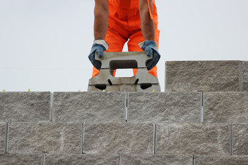 Bricklayer putting down another row of bricks in site during the construction  the viaduct.
