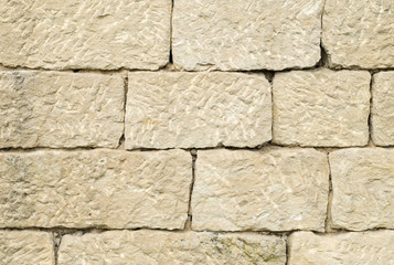 Old ecru stone wall closeup