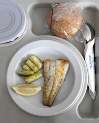 Fish and courgette served in a tray at a hospital.