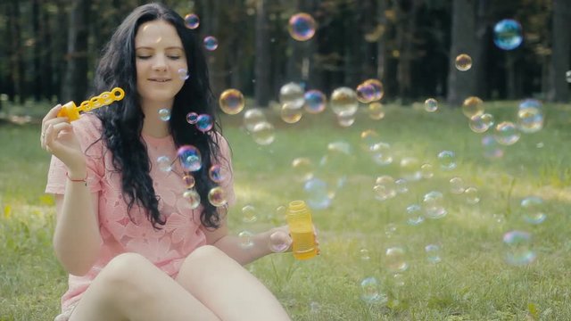 girl blowing bubbles outdoors