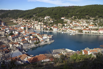 Red roofs and white stone houses in deep bay in village Pucisca on island Brac in Croatia