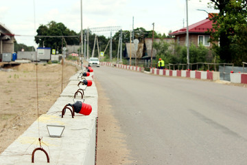 Signal lights on the fundamental blocks of concrete, fencing construction  the viaduct from the existing road.