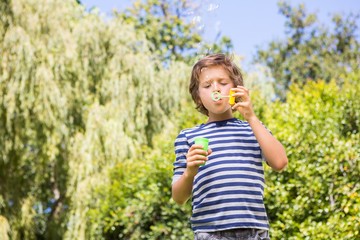 Fototapeta premium Cute boy playing with bubbles