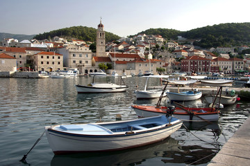 Fototapeta na wymiar Pucisca harbour with St. Jerome church on island Brac in Croatia