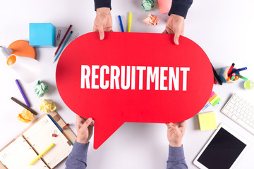 Two people holding speech bubble with RECRUITMENT concept