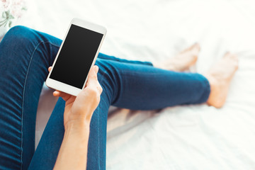 Woman with modern mobile phone in hands