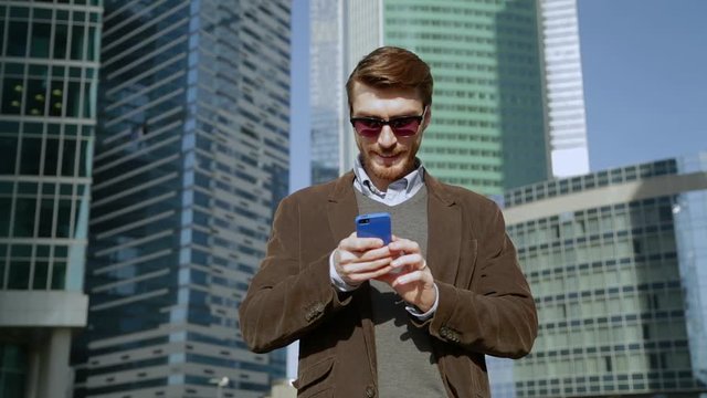 Attractive man using app on smartphone, smiling
