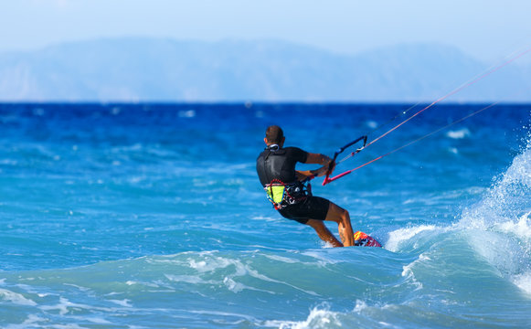 Kitesurfing, Kiteboarding action photos, man among waves quickly rides