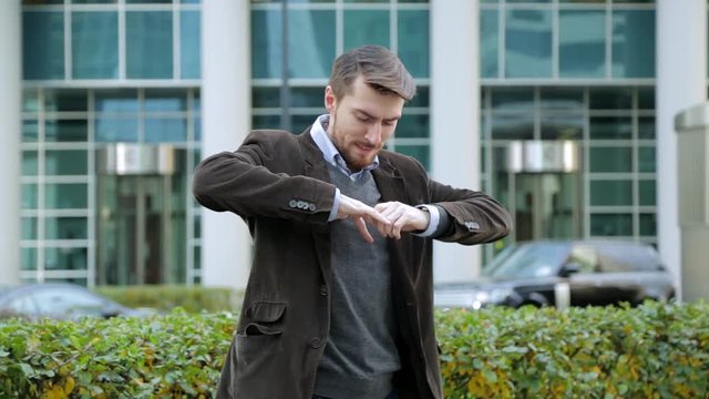 Attractive man trying to take off a ring from his finger
