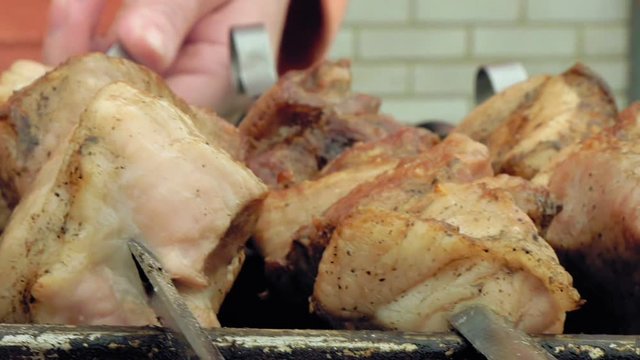 Barbeque skewers with meat cooking on hot coal ember brazier Outdoors picnic concept.