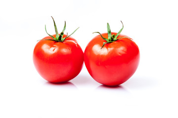 Two tomatoes isolated on a white background