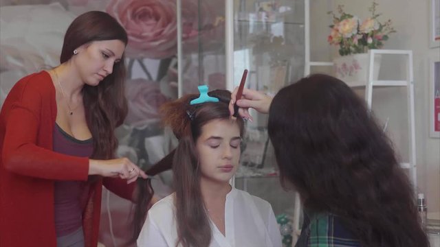 Hairdresser and make-up artist working at model image 4K