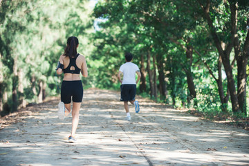 Young couple running in the park.