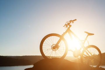 Fototapeta na wymiar Silhouette Mountain biking on the rock at sky sunset