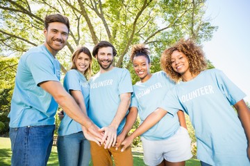 Portrait of volunteer group forming hands stack 