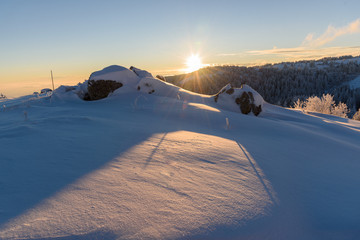 Frosty sunrise at Vitosha mountain, Sofia, Bulgaria - beautiful winter landscape - sun shining over the fresh snow powder