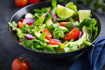 avocado, tomato and arugula salad. Healthy vegan food.