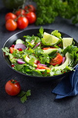 avocado, tomato and arugula salad. Healthy vegan food.
