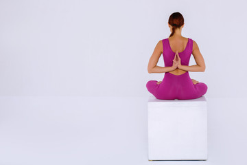 Sport yoga woman practicing yoga, sitting and folded hands behind his back.  
Concept  meditation...