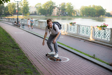 a man riding a skateboard in the park in the summer