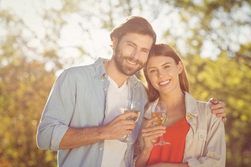 Portrait of couple holding glass of wine