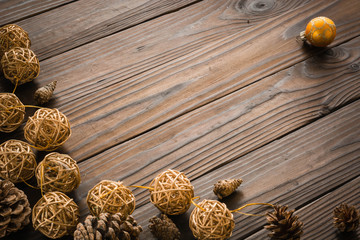 Rustic wood background with pine cones. Dark brown colors.