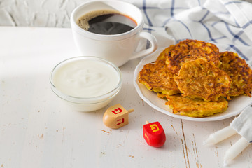Symbols of Hanukkah celebration on wood background