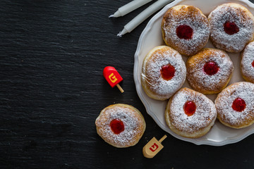 Symbols of Hanukkah celebration on wood background