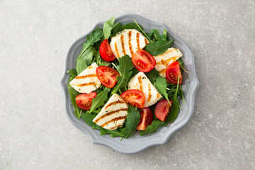 fresh salad with fried cheese, tomatoes and arugula