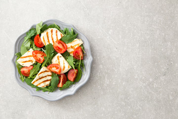fresh salad with fried cheese, tomatoes and arugula