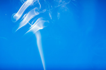 Fototapeta premium White smoke shape on a blue backgrounds