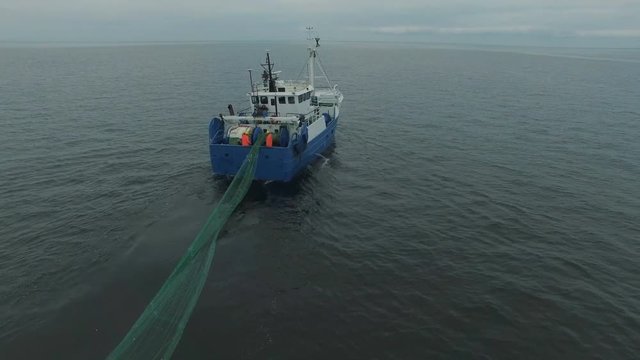  Aerial Shot of a Commercial Fishing Ship that Pulls Trawl Net. Shot on RED Cinema Camera in 4K (UHD). 