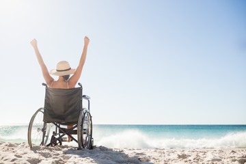 Wheelchair woman sitting  with arms up 